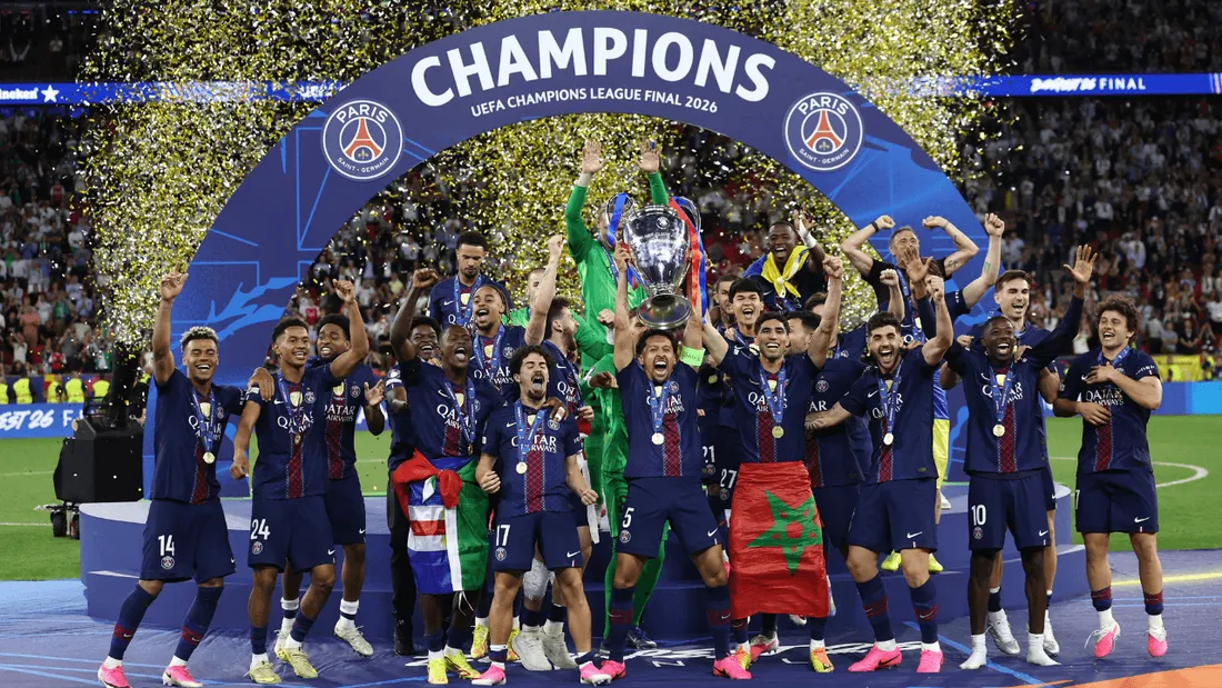 Les joueurs du PSG célèbrent leur victoire en tenant la Coupe aux grandes oreilles.